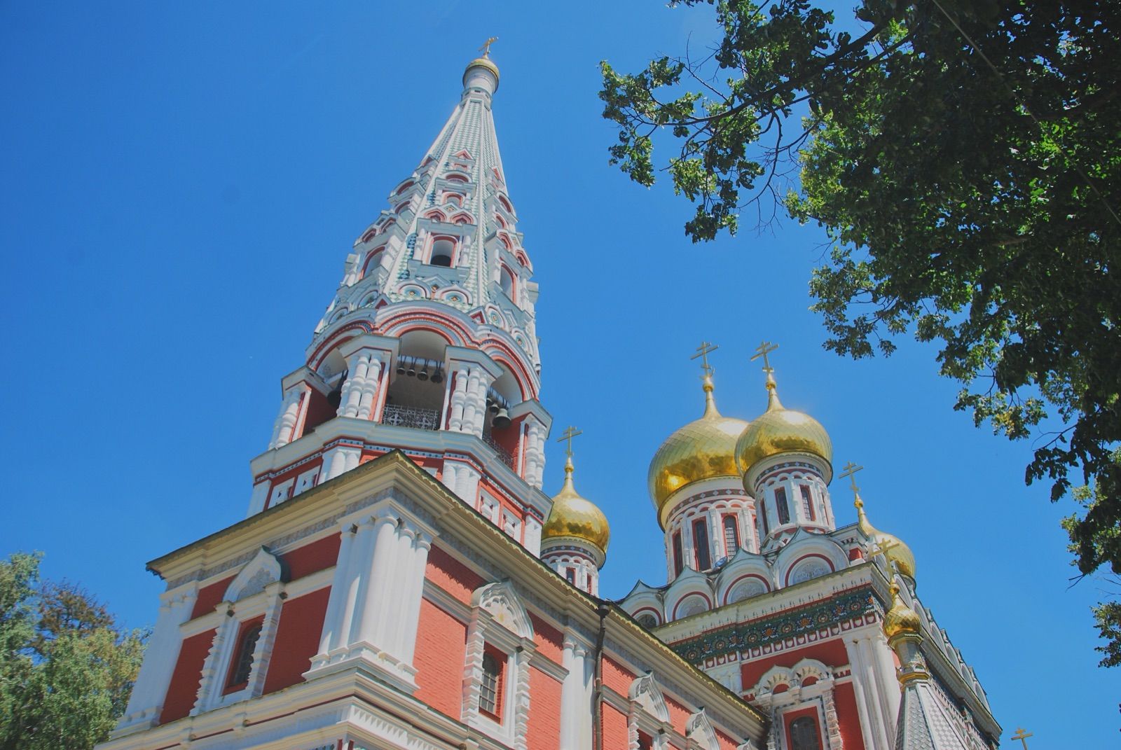 Cúpulas doradas y aguja de la iglesia memorial de Shipka de estilo ruso contra un cielo despejado
